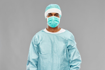 medicine, surgery and people concept - indian male doctor or surgeon in mask and protective wear...