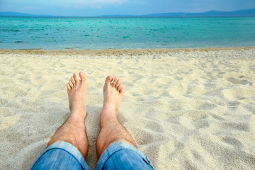 Fototapeta premium beautiful legs in the sand of the sea greece background
