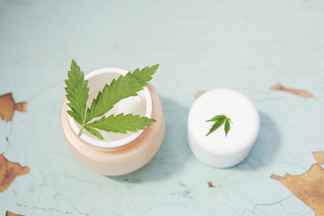 Cannabis cream with marijuana leaf in jar. Concept of herbal alternative medicine, cbd oil, pharmaceptical industry, cannabis cosmetics