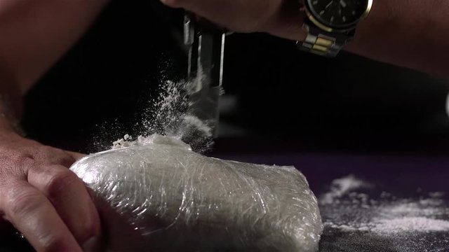 utility knife cutting bag of cocaine
