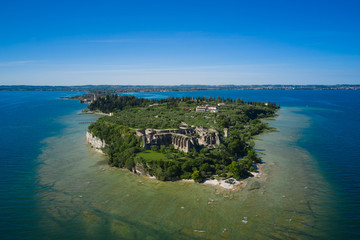 Archaeological site of Grotte di Catullo, city of Sirmione, Lake Garda, Italy. Aerial view on blue...
