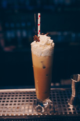 Sweet Famous white with caramels decoration slice  Author inspired Cocktail Drink - on bar counter . Close-up Top view . Copy paste space for design people and luxury service barman in nightclub