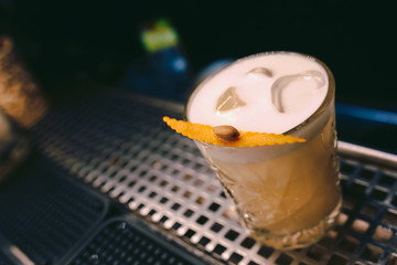 Sweet Famous white with caramels decoration slice  Author inspired Cocktail Drink - on bar counter . Close-up Top view . Copy paste space for design people and luxury service barman in nightclub