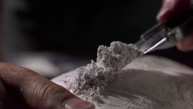 utility knife cutting bag of cocaine