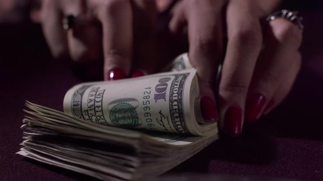 counting one hundred dollar bills in slow motion and dropping dollars