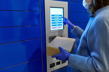 health care, mail delivery and pandemic concept - close up of woman wearing face protective medical mask for protection from virus disease with box at automated parcel machine