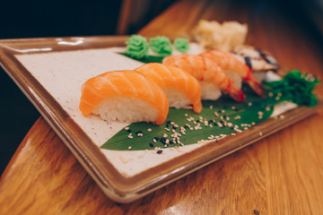 Large set of Sushi Rolls Warm Ebi Sake Unagi Spring. A lot assortment Philadelphia roll Dishes from Japanese raw fish  in one plate in traditional restaurant. Japan food menu service
