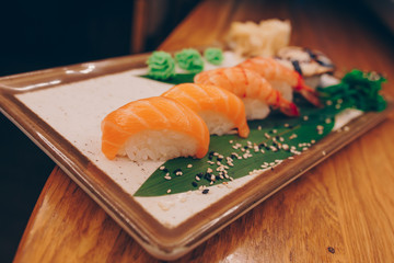 Large set of Sushi Rolls Warm Ebi Sake Unagi Spring. A lot assortment Philadelphia roll Dishes from Japanese raw fish  in one plate in traditional restaurant. Japan food menu service