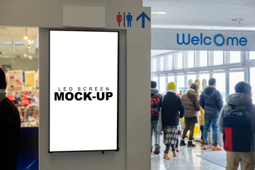Mock up vertical LED board on wall at entrance mall