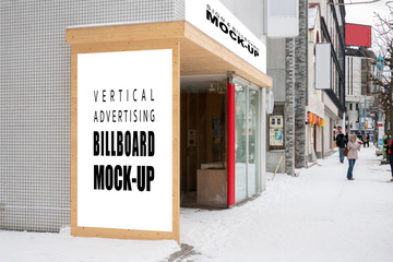 Mock up vertical billboard on wall near entrance store