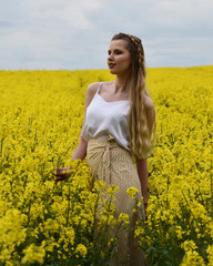 Fototapeta premium young woman in rape field