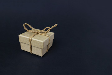 Cardboard box with a purchase or a gift on a dark background.