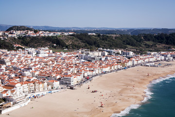 Fototapeta na wymiar Bird's-eye view on Nazare beach riviera on the coast of Atlantic ocean. Nazare. Portugal
