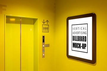 Mock up vertical signboard on yellow wall near elevator