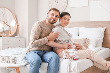 Beautiful pregnant woman with her husband at home