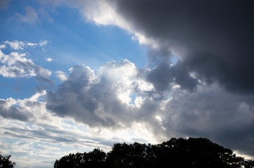 break in the dark clouds with a rainbow