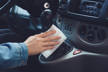 Woman disinfecting salon of car