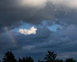Obraz na płótnie Canvas break in the dark clouds with a rainbow
