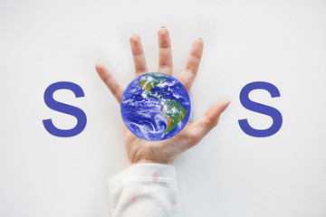 Women holding planet in hand against white background. World environment day concept. Elements of...