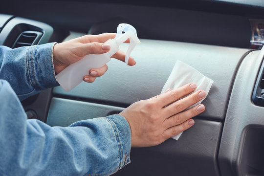 Woman Disinfecting Salon Of Car