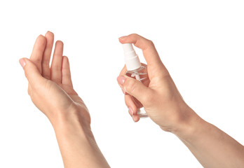 Woman using sanitizer on white background