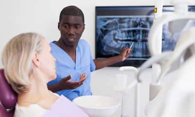Doctor dentist shows patient an x-ray