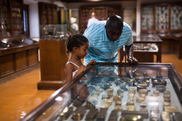 Father and daughter looking at stands with exhibits