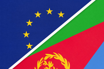 European Union or EU and Eritrea national flag from textile. Symbol of the Council of Europe association.