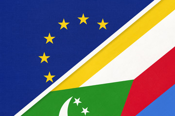 European Union or EU and Comoros national flag from textile. Symbol of the Council of Europe association.