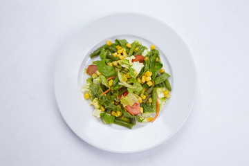 vegetable salad on white, top view