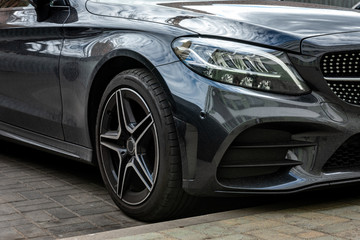 Closeup of front side of car in parking lot.