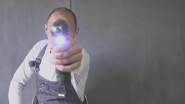 Man with a black eye with a screwdriver in hand