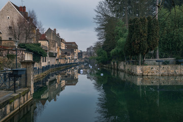 Ancient French classic medieval town with river in front, travel in a cloudy day