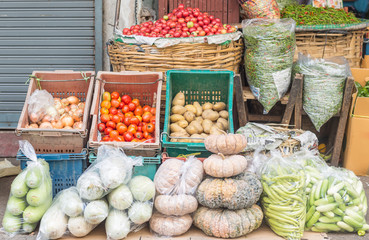 Variety of fresh vegetables displayed at the local street market stall outdoors. 