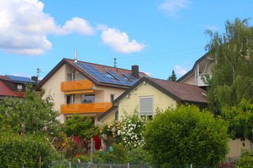 Fototapeta na wymiar Residential houses with gardens abloom (Baden, Germany)