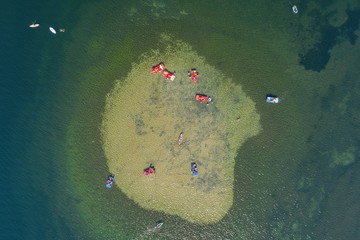 Holiday vacation on the sandy beach, water bike, kayak in the atoll lagoon water