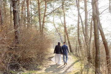 Happy pregnant couple in nature