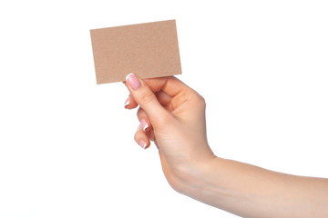 Fototapeta premium Craft paper card in female hand isolated on white