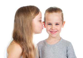 Young smiling caucasian boy and girl kisses him on the cheek isolated on white background - 353064275