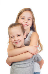 Young smiling caucasian girl and boy hugging isolated on white backgroundboy - 353064298
