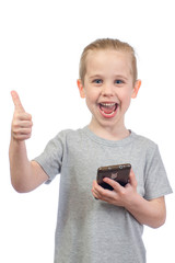 Young smiling caucasian boy with mobile phone shows thumbs up isolated on white background - 353064494
