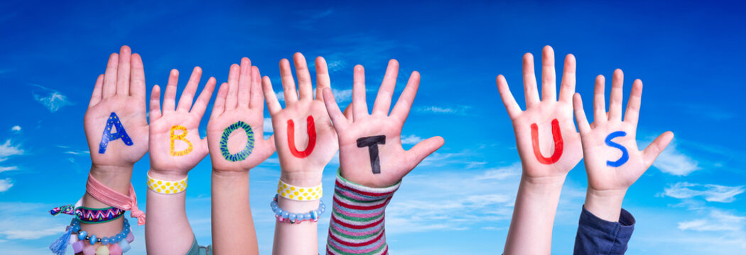 Children Hands Building Colorful English Word About Us. Blue Sky As Background