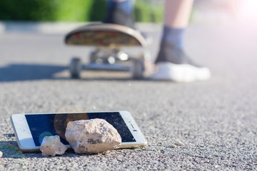 Selective focus. The child prefers to get rid of the smartphone and continue playing, enjoying the outdoors