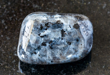 closeup of sample of natural mineral from geological collection - tumbled Larvikite (norwegian...