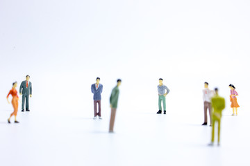 miniature businessmen keep distance away in the public. Social distancing concept avoid COVID-19 coronavirus spreading.
