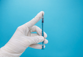 Doctor preparing an injection. Hand holds a coronavirus vaccine vial