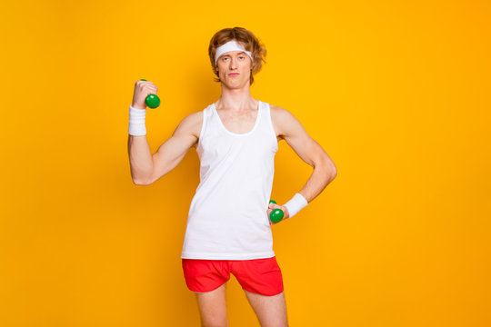 Portrait of his he nice attractive funky focused arrogant content proud guy doing work out with small easy dumbbell endurance isolated over bright vivid shine vibrant yellow color background