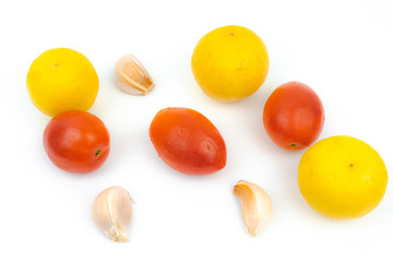 Lime,oval tomatoes,and garlic isoalted on white backgorund