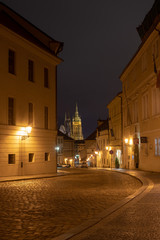 A night at the district of Hradcany in Prague with the cathedral of the Prague castle visible in the distance.
