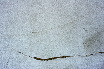 Texture of a concrete wall with cracks and scratches which can be used as a background